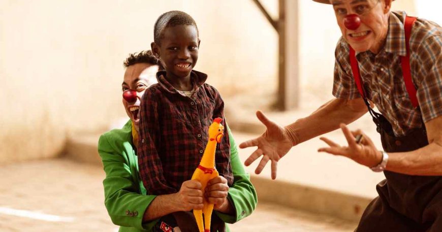 A Sudanese boy smiles as he performs with clowns in Egypt.