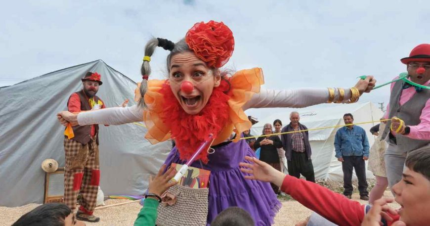 Clowns perform for kid survivors of the Turkey earthquakes as kids reach out to participate.
