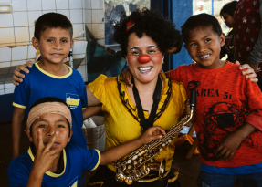 Clown with kids and a saxophone