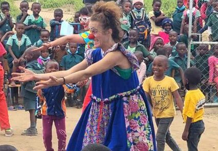 Woman dancing with a group of kids