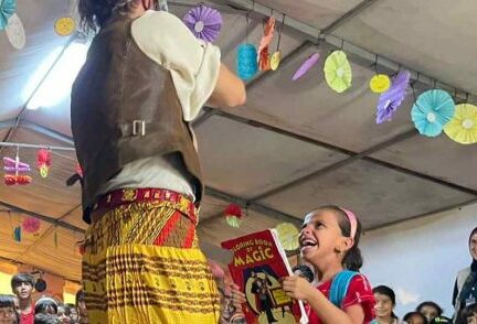 Clown with child holding a magic book