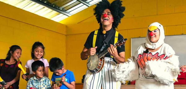 Clown with ukulele and chicken suit