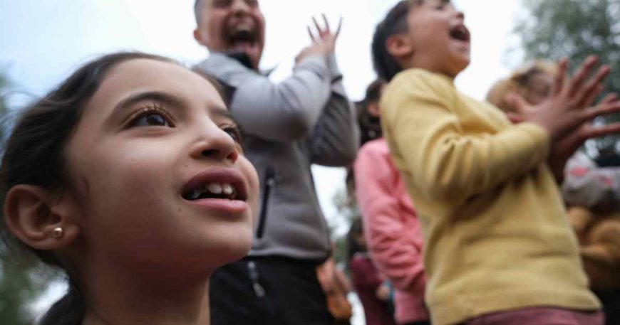Children survivors of the Turkey earthquake clap at a clown show.