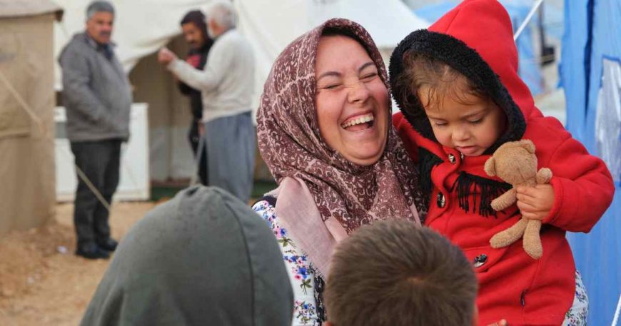 Survivors of the earthquake in Turkey take time to laugh, like this woman with her child.
