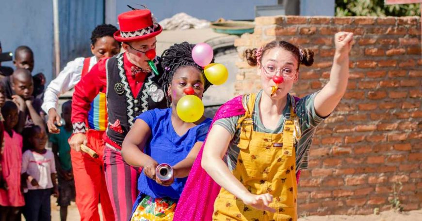 Four clowns run with kazoos and horns as they defend kids' right to play in Zimbabwe.