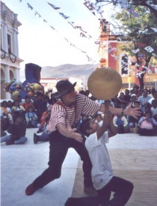 chiapas, mexico. boy youth audience member spins a large ball on his finger. celebrating our 100th project