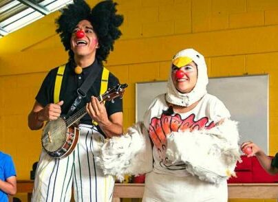Clowns with a ukulele and chicken outfit