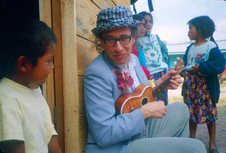 Man playing ukulele for kid