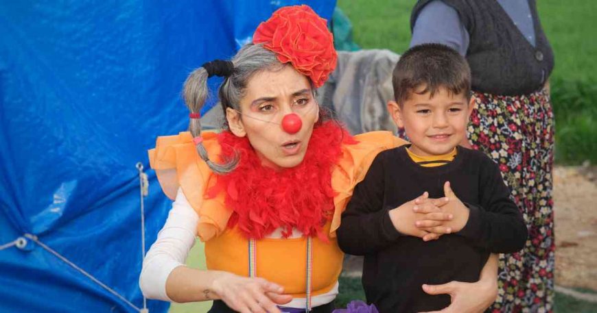 A clown hugs a boy as part of clown show in Turkey