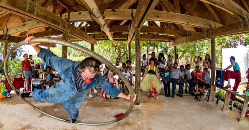 A clown performs on his cyr wheel in front of an audience in Puerto Rico.