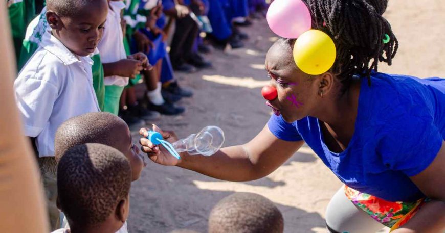 A child blows a bubble during a clown show in Zimbabwe.