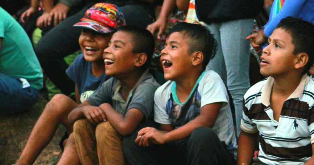 Kids laughing at a clown show in Guatemala.